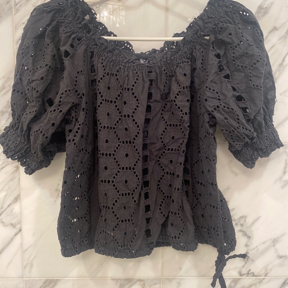 Casting black cotton blouse with cut outs.